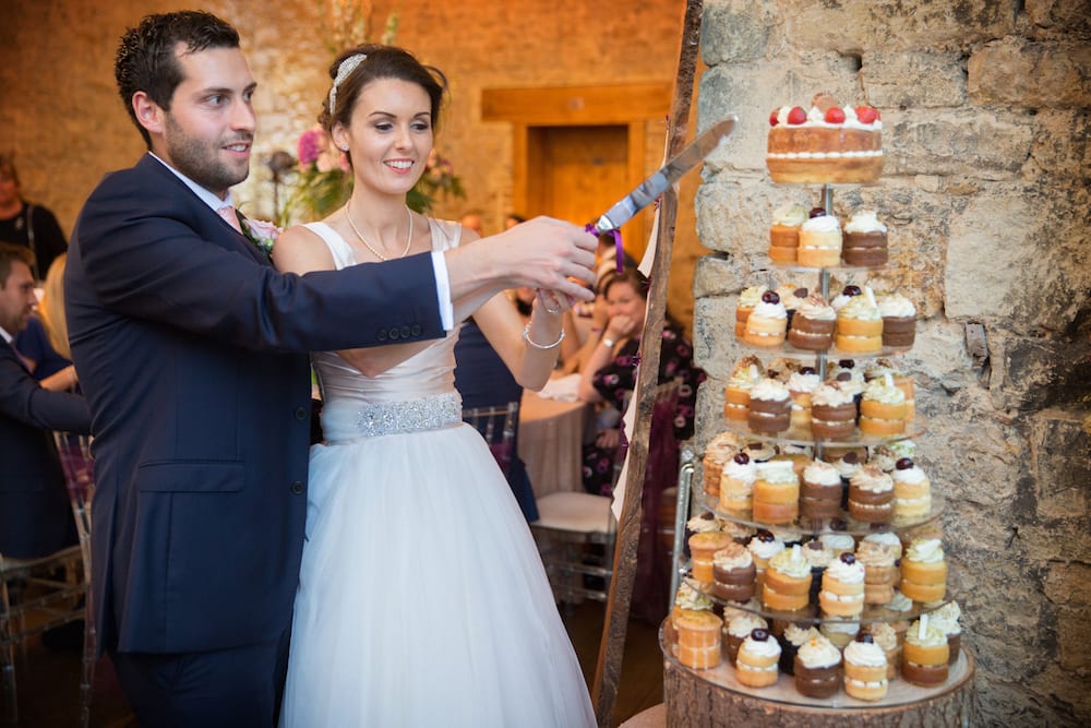 tiered homemade cupcake tower on clear cake stand