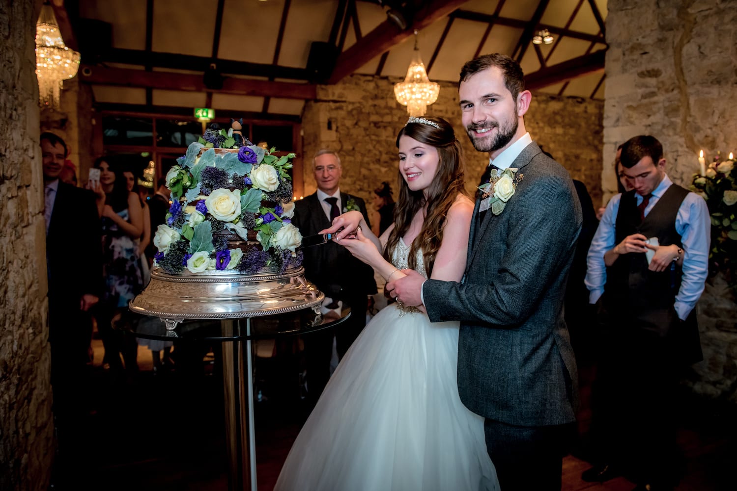 Notley Abbey tiered floral wedding cake cutting