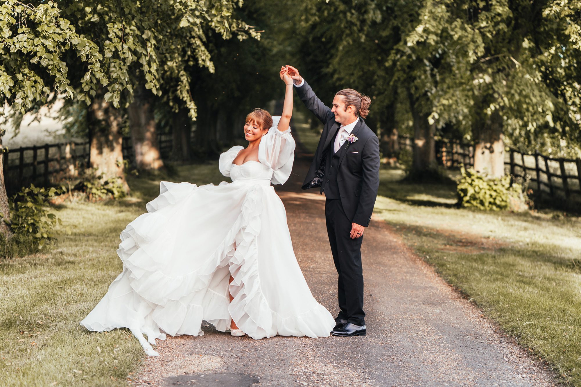 Harper wedding venues Notley Abbey couple dancing on the treelined driveway